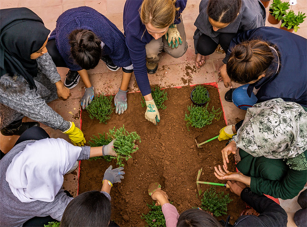 REEP volunteers teaching gardening skills to girls living in a boarding house in Morocco.