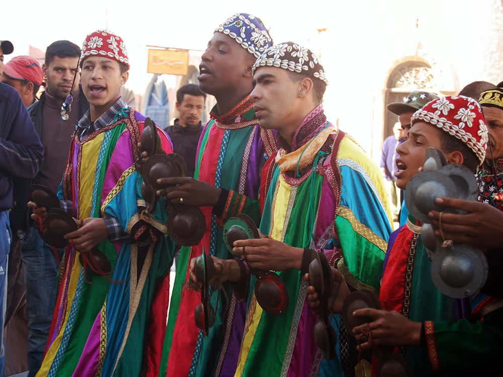 Shore to Shore Festival: Moroccan gnaoua musicians performing during the parade in Essaouira, Morocco