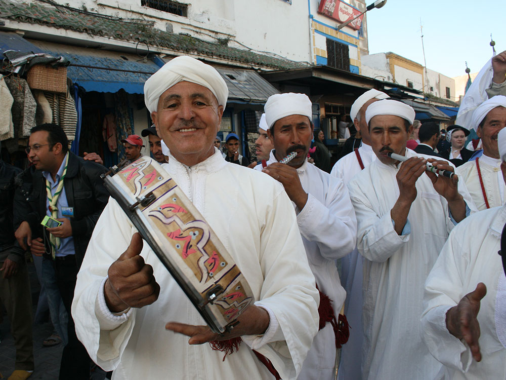 Shore to Shore Festival: Traditional Moroccan musicians performing during the parade in Essaouira, Morocco